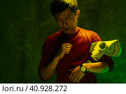 Chinese man holding respirator mask. Air pollution concept. Стоковое фото, фотограф Сергей Толмачёв / Фотобанк Лори
