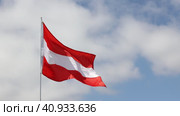Large flag of Austria fixed on metal stick waving against background of cloudy sky during daytime. Стоковое видео, видеограф Яков Филимонов / Фотобанк Лори