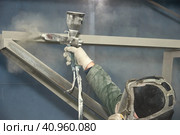 A man produces powder paint metal products. Стоковое фото, фотограф Стас Пересыпкин / Фотобанк Лори
