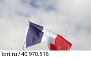 Large flag of France fixed on metal stick waving against background of cloudy sky during daytime. Стоковое видео, видеограф Яков Филимонов / Фотобанк Лори