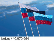 Flags of Russia and the partially recognized republics of Donetsk and Lugansk oblasts on a blue background. Close-up of banners fluttering in the wind. Стоковое фото, фотограф Алексей Игнатов / Фотобанк Лори