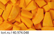 Slices of fresh pumpkin chunks background. Yellow Juicy pieces of pumpkin. Texture close up. Turning, rotation. Full frame with copy space for text, label. Food backdrop. Bright orange sliced pumpkin. Стоковое видео, видеограф Марина Демидюк / Фотобанк Лори