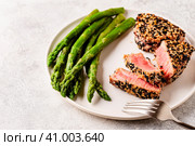 Tuna steak fried in sesame seeds served with asparagus. Стоковое фото, фотограф Татьяна  Бральнина / Фотобанк Лори