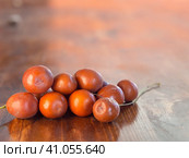 Marmalade- jujube or Chinese date on a wooden background. Close-up of a pile of ripe ziziphus, rich in vitamins and minerals, on a wooden surface. Small depth of focus. Ripe sweet berries. jujube. Стоковое фото, фотограф Александр Кротков / Фотобанк Лори