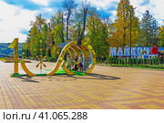 Знак символ к столетию республики Адыгея в парке города Майкопа осенним вечером (2022 год). Редакционное фото, фотограф Андрей С / Фотобанк Лори