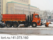 Moscow, Russia - January 22, 2021: Municipal city service cleans city street from snow after blizzard in Moscow. Side view. Urban industrial concept. Редакционное фото, фотограф YuryKara / Фотобанк Лори