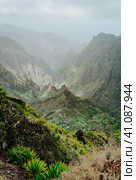 Breathtaking panorama of deep lush ribeira surrounded by towering peaks. Verdant Xo-Xo valley on Santo Antao Island Cape Verde. Стоковое фото, фотограф Igor Tichonow / Фотобанк Лори