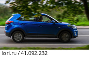 Side view of Hyundai Creta blue color, which is driving on rural highway. Редакционное фото, фотограф Константин Григорьев / Фотобанк Лори