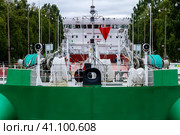 Vytegra, Russia - August 16, 2015: Cargo ship entered the White Sea-Baltic Canal Gateway. It connects the White Sea, in the Arctic Ocean, with Lake Onega, which is further connected to the Baltic Sea. Редакционное фото, фотограф VittoriaChe / Фотобанк Лори