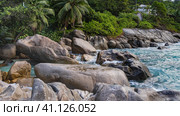 Picturesque boulders on the ocean coast. Turquoise waves are beating against the rocks.Lush tropical vegetation on the shore. Seychelles. Mahe. Стоковое фото, фотограф Вера Ивановна Кубарева / Фотобанк Лори