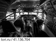 BERLIN, GERMANY - APRIL 25, 2018: Cockpit of Boeing E-3A Sentry AWACS. Black and white. Exhibition ILA Berlin Air Show 2018. Редакционное фото, фотограф Sergey Kohl / Фотобанк Лори