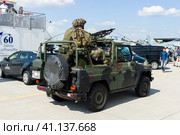 BERLIN, GERMANY - JUNE 03, 2016: Soldiers and officers of the German army (Bundeswehr) in the car. Exhibition ILA Berlin Air Show 2016. Редакционное фото, фотограф Sergey Kohl / Фотобанк Лори