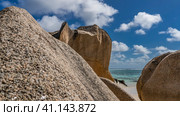 Huge granite boulders against a background of blue sky, clouds, turquoise ocean. Bizarre outlines, smoothed slopes. Close-up. Seychelles. La Digue. Anse Source D’Argent beach. Стоковое фото, фотограф Вера Ивановна Кубарева / Фотобанк Лори
