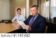 Woman boss firing upset adult male employee. Стоковое фото, фотограф Яков Филимонов / Фотобанк Лори