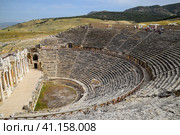Ancient antique amphitheater in city of Hierapolis in Turkey. Steps and antique statues with columns in the amphitheater (2019 год). Стоковое фото, фотограф Леонид Еремейчук / Фотобанк Лори