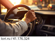 Hand on the steering wheel of the car. Sunset lighting. Стоковое AI-изображение, AI-художник Поликарпов Владимир Владимирович / Фотобанк Лори