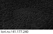 Around the laid stone tiles, like a web. Black - gray monochrome image. Стоковая иллюстрация, иллюстратор Юлия Петровская / Фотобанк Лори