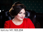 Plus size fashion model in red dress with professional make-up and hairstyle. Стоковое фото, фотограф Станислав Тарко / Фотобанк Лори