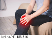 Man with pain in knee suffering at home. Стоковое фото, фотограф Станислав Тарко / Фотобанк Лори