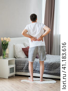 Back pain, kidney inflammation, man suffering from backache at home. Стоковое фото, фотограф Станислав Тарко / Фотобанк Лори