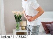 Man with abdominal pain suffering at home. Стоковое фото, фотограф Станислав Тарко / Фотобанк Лори