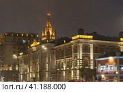 Moscow, Russia - October 23, 2022: Image of Moscow architecture. Stalinist skyscraper on Barrikadnaya metro station in night bright illumination. Garden Ring or Sadovoye Koltso - circular ring. Редакционное фото, фотограф YuryKara / Фотобанк Лори