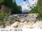 Waterfall during opened locks for idle discharge of water at a small hydroelectric power station. Стоковое фото, фотограф Евгений Харитонов / Фотобанк Лори