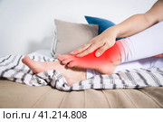 Woman's leg hurts, pain in the foot, massage of female feet. Стоковое фото, фотограф Станислав Тарко / Фотобанк Лори