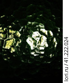 Corrugated green glass background. Abstract translucent volumetric texture pattern on the surface of a window. Liquid horror or planet Solaris. Night or space theme. Стоковое фото, фотограф Юлия Петровская / Фотобанк Лори