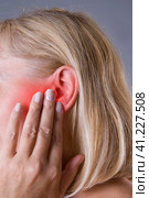 Woman with earache, ear pain closeup. Стоковое фото, фотограф Станислав Тарко / Фотобанк Лори