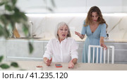 Offended senior woman listening her daughter swearing at home. Стоковое видео, видеограф Яков Филимонов / Фотобанк Лори