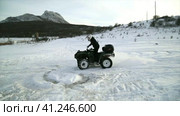 Impassability. Riding a quad bike in winter in the snow. Непроходимость. Катание на квадроцикле зимой по снегу. (2016 год). Редакционное видео, видеограф Egor Sarantstv / Фотобанк Лори