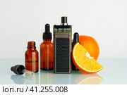 Vape liquid with orange flavor on white background. Стоковое фото, фотограф Сергей Толмачёв / Фотобанк Лори