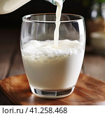 Fresh milk is poured into a clear glass glass. Generated by AI. Стоковое AI-изображение, AI-художник Ярославский Максим / Фотобанк Лори