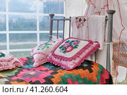 Traditional decor of bed in Tatar vintage style. Woven bedspread, pillows embroidered with ribbons. Стоковое фото, фотограф Ирина Кононова / Фотобанк Лори