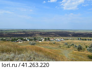 Blasted fields outside the village. The fact that left a fire on the field. the village from the hill view (2015 год). Стоковое фото, фотограф Леонид Еремейчук / Фотобанк Лори
