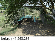 Camouflage Cape canopy over the gazebo and bench. Стоковое фото, фотограф Леонид Еремейчук / Фотобанк Лори