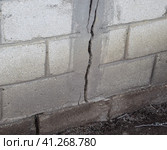 A crack in the concrete wall. The destruction of the wall from the gray blocks. Стоковое фото, фотограф Леонид Еремейчук / Фотобанк Лори