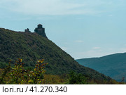 The Temple of the Cross of the Jvari monastery on the mountain against the blue sky. Mtskheta.Georgia. 01.09.23 (2023 год). Редакционное фото, фотограф Ярославский Максим / Фотобанк Лори