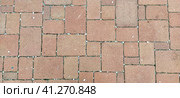 Cobbled street of the old city, lined with square and rectangular stone tiles. Soft beige, brown and gray colors and tones. The texture of the stone. Geometric pattern. Стоковое фото, фотограф Юлия Петровская / Фотобанк Лори