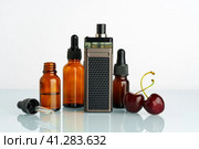 Vape liquid with cherry flavor on white background. Стоковое фото, фотограф Сергей Толмачёв / Фотобанк Лори
