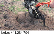 Powerful cultivator, Tiller. Gardening. Spring work on the farm. Land cultivation with a Motor ripper. Man plows the ground. Spring soil preparation for seeding. Husbandman, grower. Moto plow working. Стоковое видео, видеограф Марина Демидюк / Фотобанк Лори