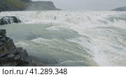Cliff and falling water from the edge of Gullfoss waterfall in Iceland located in the Golden circle. Стоковое фото, фотограф Igor Tichonow / Фотобанк Лори