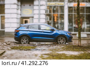 Blue Geely Coolray car parked at street. Side view of chinese crossover Geely binyue. Редакционное фото, фотограф Константин Григорьев / Фотобанк Лори