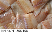 Raw fish fillet is spinning. Top view. Slices of fresh whitefish. Full frame. Sashimi rotation. Close up. Marine market. Video for sale. Cod, pollock loin steaks. Pangasius, tilapia pieces background. Стоковое видео, видеограф Марина Демидюк / Фотобанк Лори