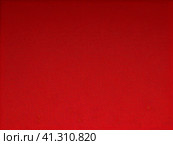 The background is red or scarlet. A beautiful festive heterogeneous textured background with specks, dots, veins, fibers, relief and other textures. Gradient change in color and awareness. Copy space. Стоковое AI-изображение, AI-художник Юлия Петровская / Фотобанк Лори