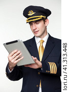 Young man in the form of a passenger plane pilot. Стоковое фото, фотограф Андрей Аркуша / Фотобанк Лори