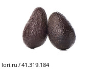 Two haas avocado fruits isolated over the white background. Стоковое фото, фотограф Сергей Долгов / Фотобанк Лори