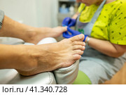 concept of male pedicure, cosmetologist makes classic pedicure for an elderly male client. Стоковое фото, фотограф Светлана Акифьева / Фотобанк Лори