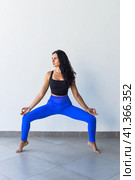 goddess squat or utkata konasana yoga with ukrainian woman making it indoors. Стоковое фото, фотограф Татьяна Терехина / Фотобанк Лори